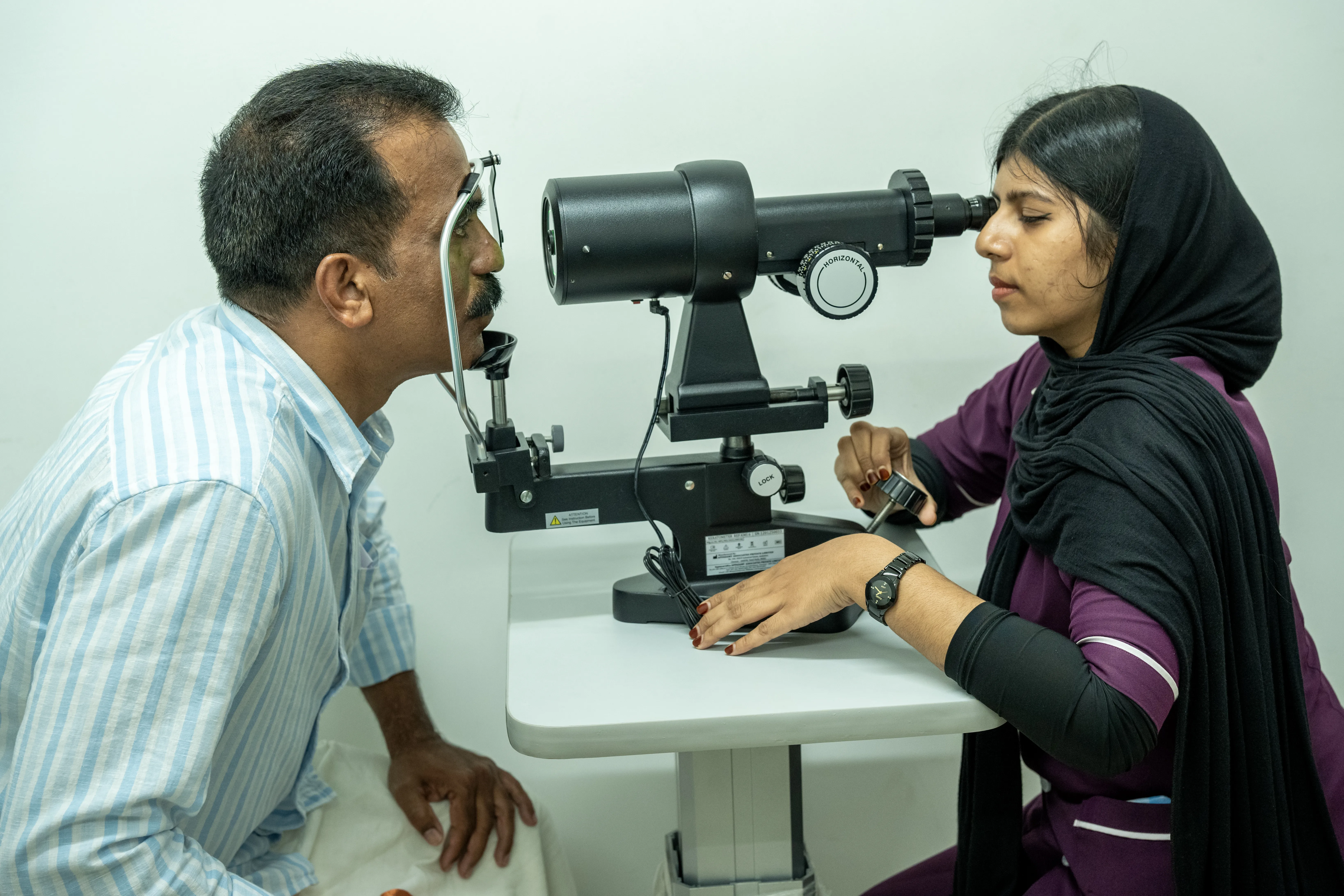 Ophthalmologist conducting a slit lamp eye examination on a patient at Kiranam Eye Clinic, Kechery